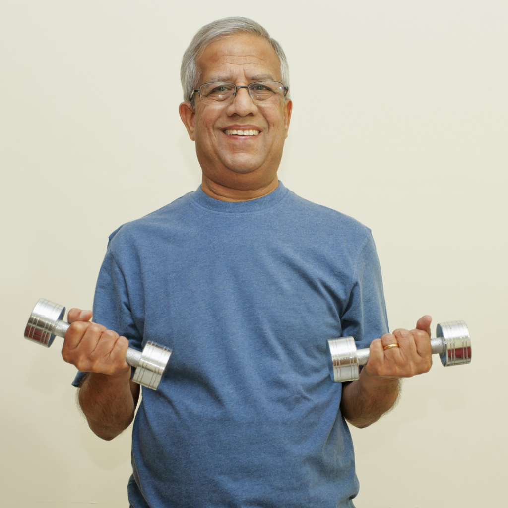 A man holding two dumbbells, demonstrating strength and fitness.