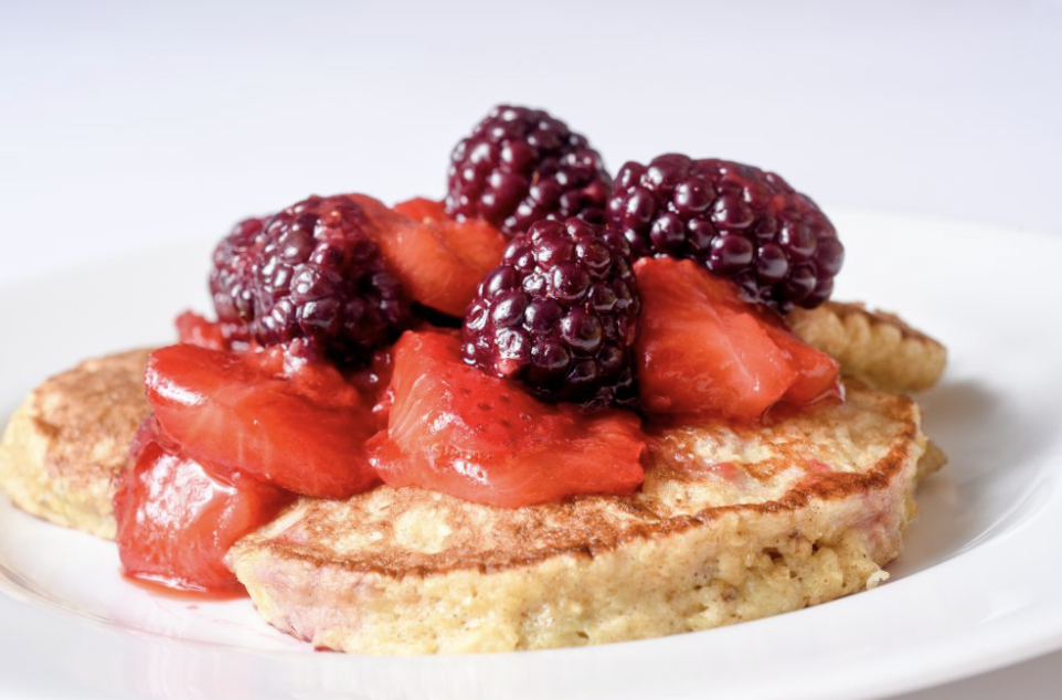 Banana Oatmeal Pancake with strawberry slices and blackberries on top.